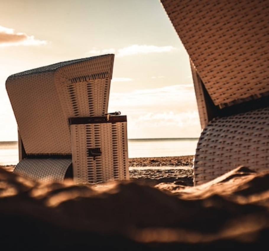 Close-up of beach chairs on the beach at sunset.