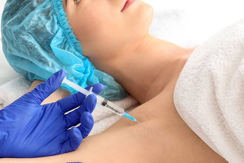 Woman receives a Botox injection to combat underarm sweat while on vacation at the Arkona Strandhotel on Rügen.