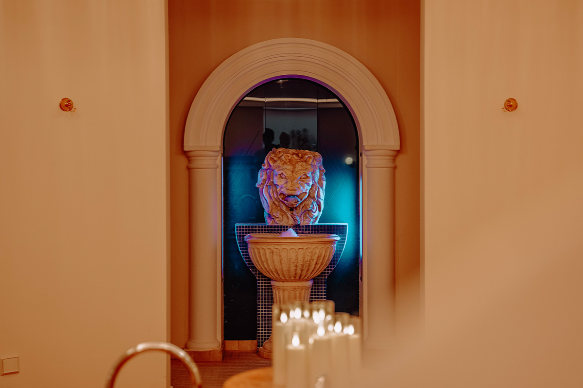 The interior of the sauna and pool area, decorated with candles and warm lighting, at the Rugard Thermal Strandhotel
